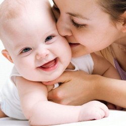 Child's Love - Mother Kissing Her Baby Child's Love - Mother Kissing Her Baby