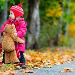 Cute Baby With Teddy In A Park