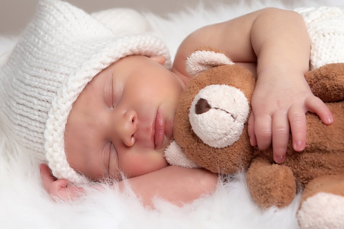 cute baby sleeping with teddy